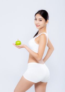 Portrait asian woman smiling holding green apple fruit and beautiful body diet with fit isolated on white background, girl weight slim with cellulite or calories, health and wellness concept.