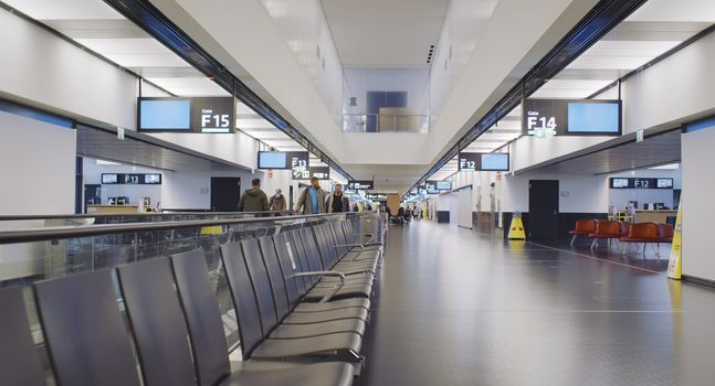 Vienna, Vienna/Austria - November 2nd 2020: Passengers walking to departure gates at Vienna airport. Only a few people travelling and a lot of closed gates.