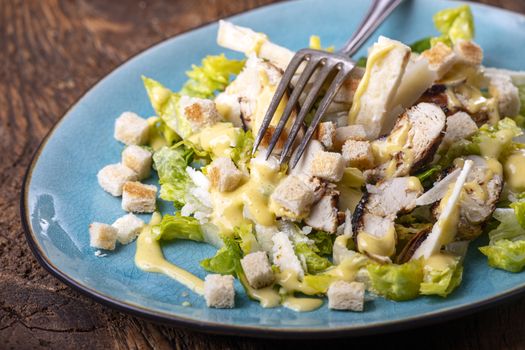 caesar salad on a blue plate