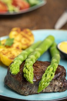 asparagus with potatoes and a steak