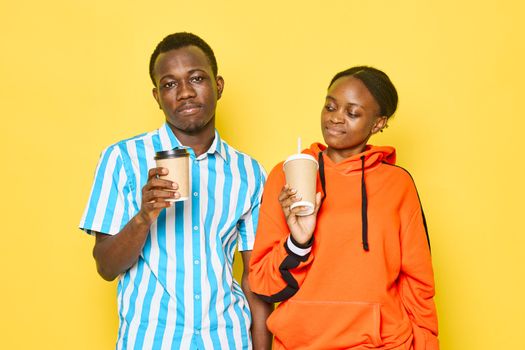 An African man and a woman with a cup of coffee in her hand