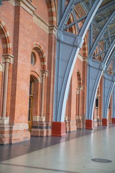 Portrait View of the red brick walls and gray Metal Arches of the St Pancras railway station -built in 1861- from London, UK
