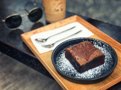 Dark chocolate brownies served with coffee 