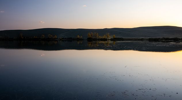 Lake in the Altai Mountains. Panorama of the Altai landscape in the mountains. The time of year is autumn.