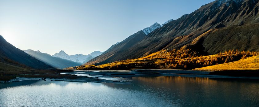 Lake in the Altai Mountains. Panorama of the Altai landscape in the mountains. The time of year is autumn.