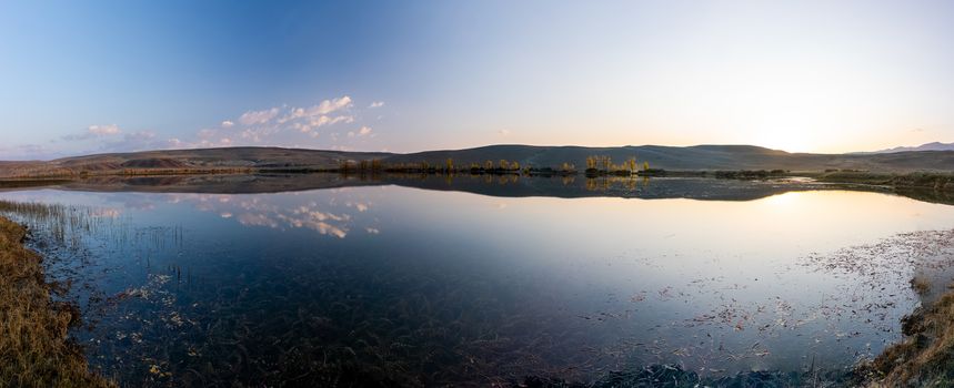 Lake in the Altai Mountains. Panorama of the Altai landscape in the mountains. The time of year is autumn.