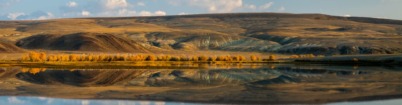 Lake in the Altai Mountains. Panorama of the Altai landscape in the mountains. The time of year is autumn.