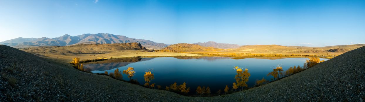 Lake in the Altai Mountains. Panorama of the Altai landscape in the mountains. The time of year is autumn.