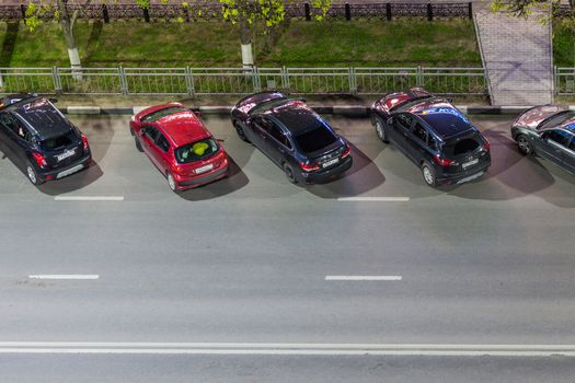 TULA, RUSSIA - MAY 12, 2017: View above on night road side parking in city at summer