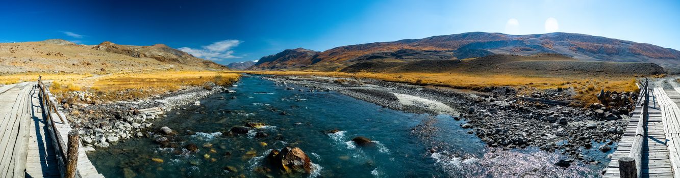 Panorama is the Altai, a mountain river flowing between the Altai mountains and the nature of the area.