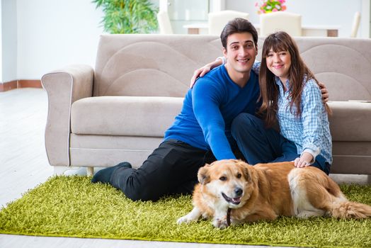 Happy family with golden retriever dog