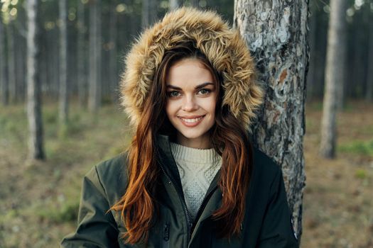 Smiling woman on nature near tree fresh air freedom. High quality photo