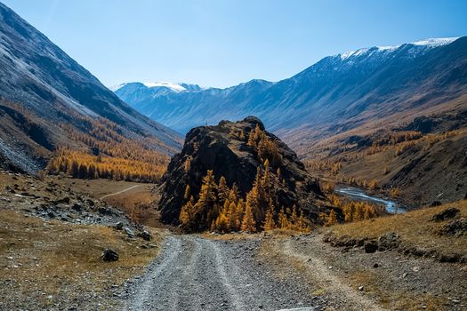 A dirt road in the mountains. The road to the rock. Altai.