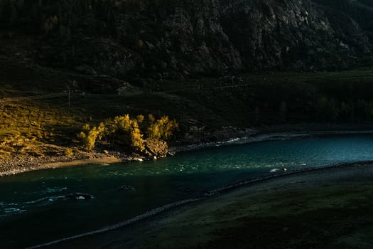 The mountain river flows over the rocks. The rivers are altai. Nature is altai.