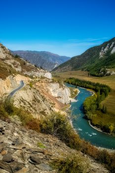 The mountain river flows over the rocks. The rivers are altai. Nature is altai.