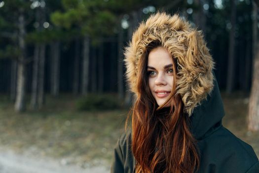 Woman tourist in autumn jacket with a hood on nature travel vacation. High quality photo