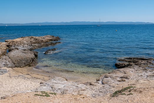 Discovery of the island of Porquerolles in summer. Deserted beaches and pine trees in this landscape of the French Riviera, Var.