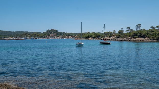 Discovery of the island of Porquerolles in summer. Deserted beaches and pine trees in this landscape of the French Riviera, Var.