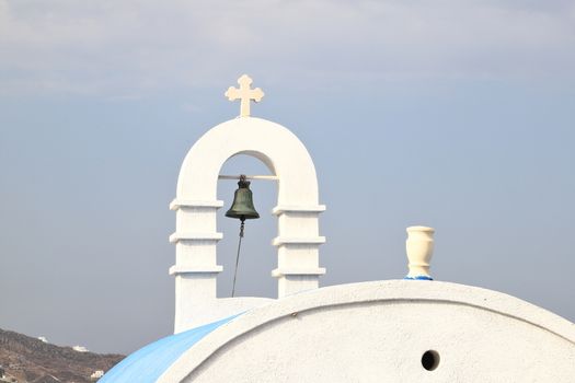 A view of a chapels bell tower on the Greek island of Mykonos.