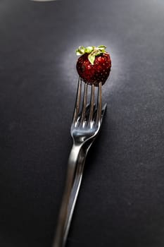 composition with strawberry and forks viewed in various perspectives on wooden table