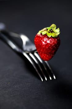 composition with strawberry and forks viewed in various perspectives on wooden table