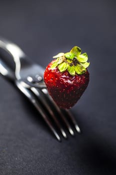 composition with strawberry and forks viewed in various perspectives on wooden table