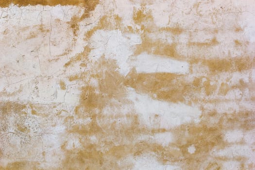 Yellow and white plaster wall background with cracks