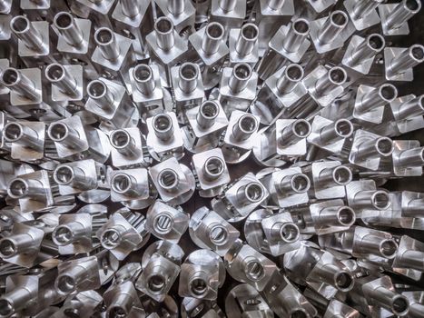 Shiny aluminium cnc machined parts background with selective focus close up technique.