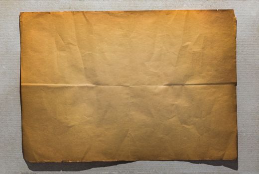 single old flat sheet of paper folded twice on white background
