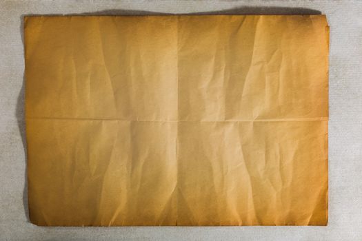 single old flat sheet of paper folded twice on white background