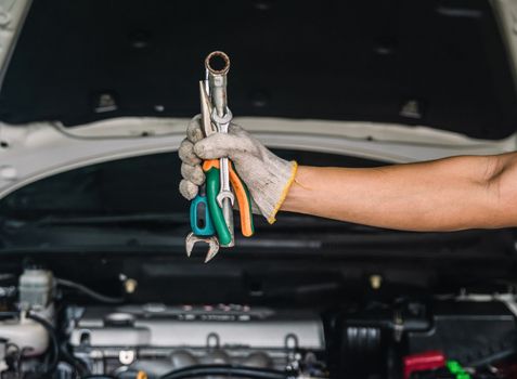 Hand of car mechanic with wrench auto mechanic Repair maintenance and car inspection