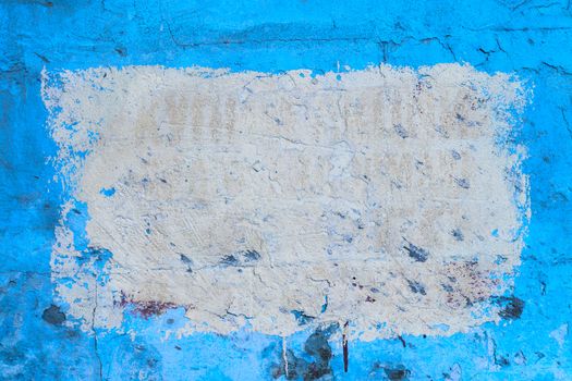 Blue plsater wall with black mold background and white rectangular on it.