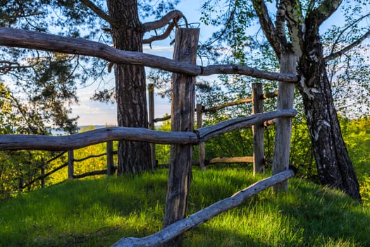 rustic view with log fence on hill