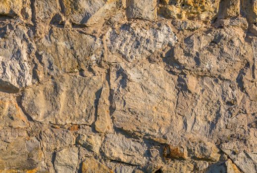 old limestone wall surface flat background with direct hard sunllight