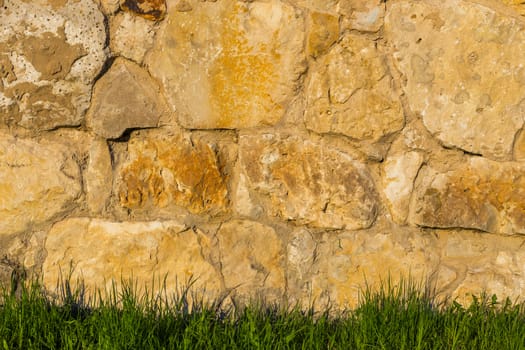 limestone wall and grass under it horizontal background