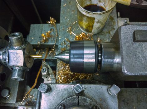 old manual lathe closeup with selective focus, custom collet chuck and center