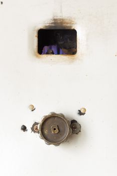 Fired up old russian gas water heater with flat front panel closeup