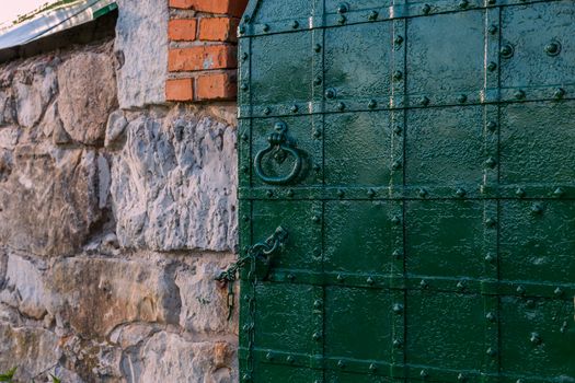 dark green riveted door background with selective focus