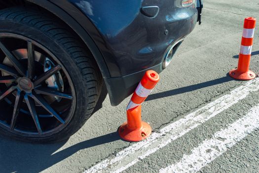 Car collide and breking smal orange plasticl traffic cone with stripes