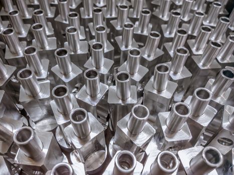Shiny aluminium cnc machined parts background with selective focus close up technique.