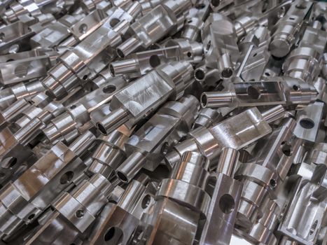 Shiny aluminium cnc machined parts background with selective focus close up technique.