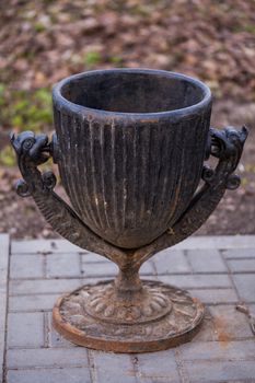 black painted thick cast iron trash bin with dragon heads sculpture elements on joints