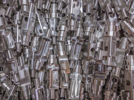 Shiny aluminium cnc machined parts flat background.