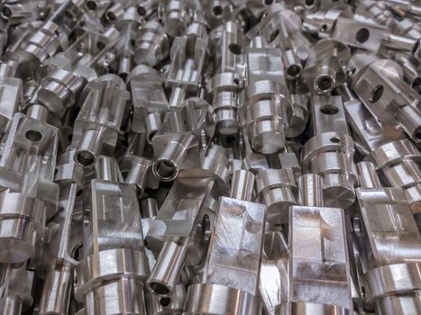 Shiny aluminium cnc machined parts background with selective focus close up technique.