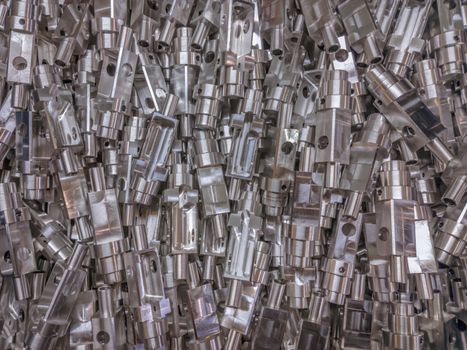 Shiny aluminium cnc machined parts flat background.