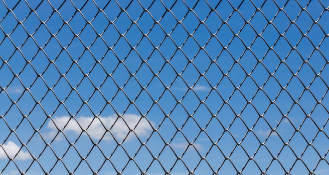 Metal mesh and blue sky background