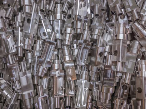 Shiny aluminium cnc machined parts flat background.