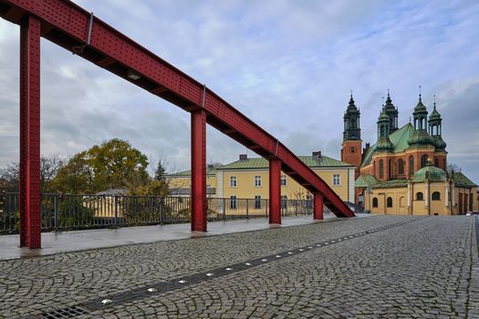 The steel structure of the bridge and the towers of the Gothic Catholic cathedral in Poznan