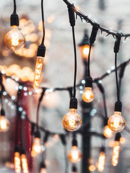 Vintage light bulbs with glow filament. Incandescent retro design. Outdoor decoration for New Year and Christmas celebration. Moscow, Russia.