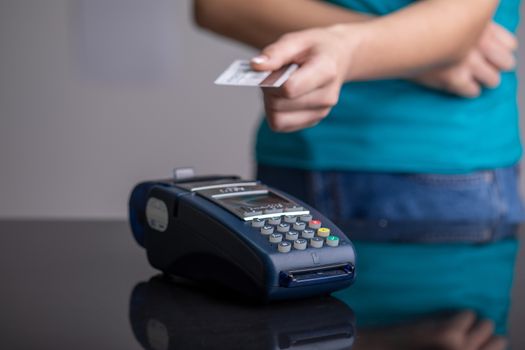 Payment by contactless credit card through the POS terminal stock photo